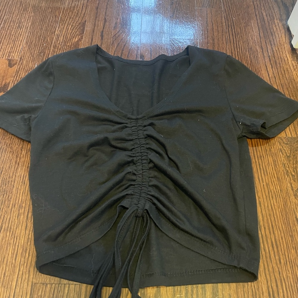 Black top with drawstring in the middle